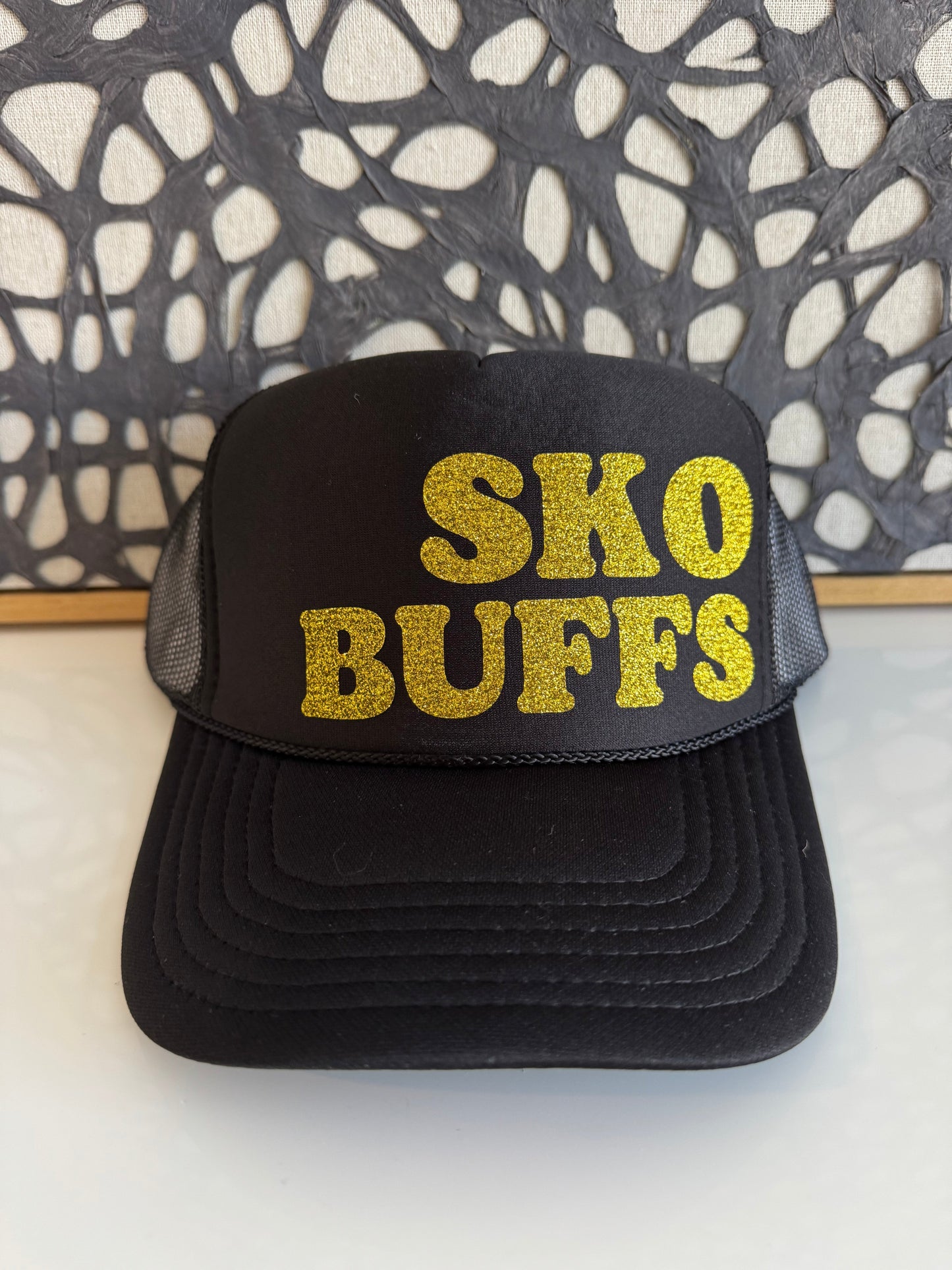 SKO BUFFS gold sparkle on a black trucker