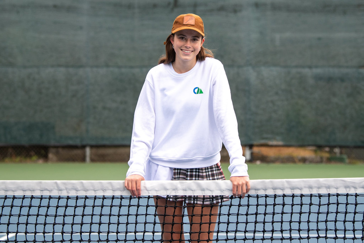 THE AGGIE BROWN PLAID SKORT— POLISHED PLAID FOR PLAY, PRACTICE, AND POST-MATCH PLANS.
