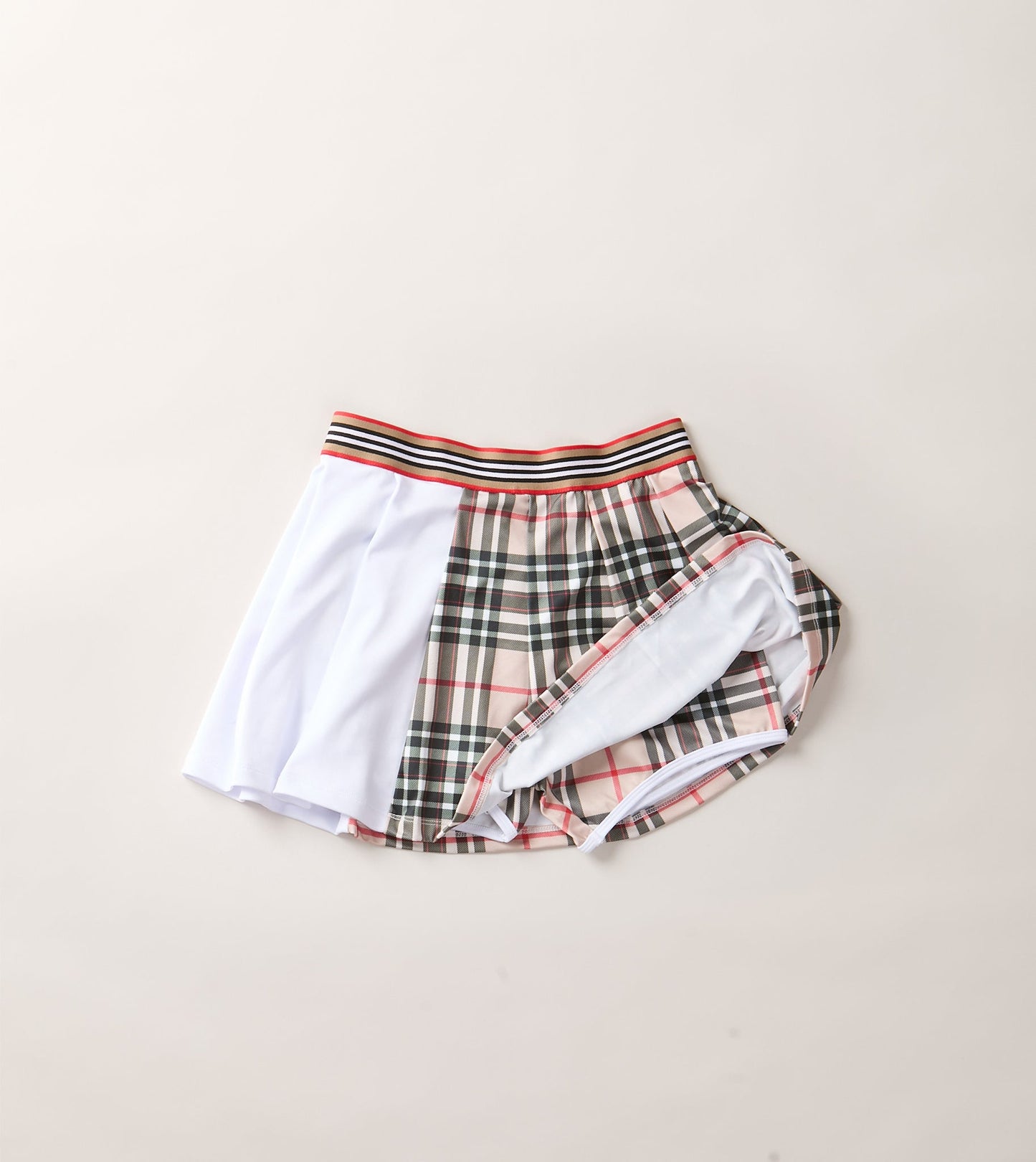 THE AGGIE BROWN PLAID SKORT— POLISHED PLAID FOR PLAY, PRACTICE, AND POST-MATCH PLANS.