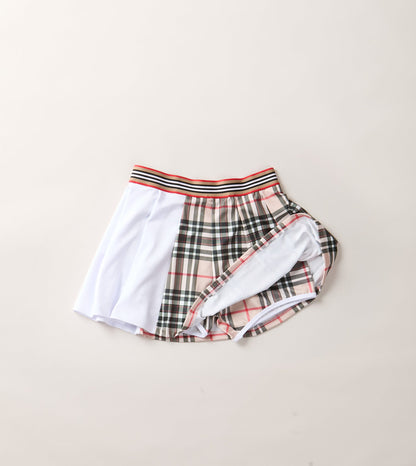 THE AGGIE BROWN PLAID SKORT— POLISHED PLAID FOR PLAY, PRACTICE, AND POST-MATCH PLANS.
